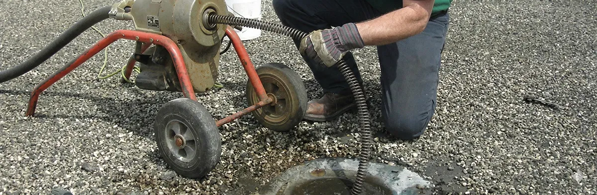 sewer rodding technician actively removing blockages from a sewer line in Wilmington, NC
